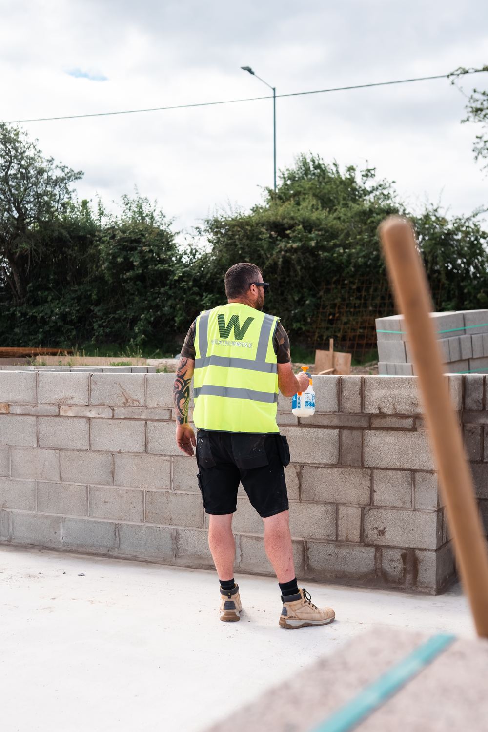 Weatherwise team member in hi-vis treating new blockwork